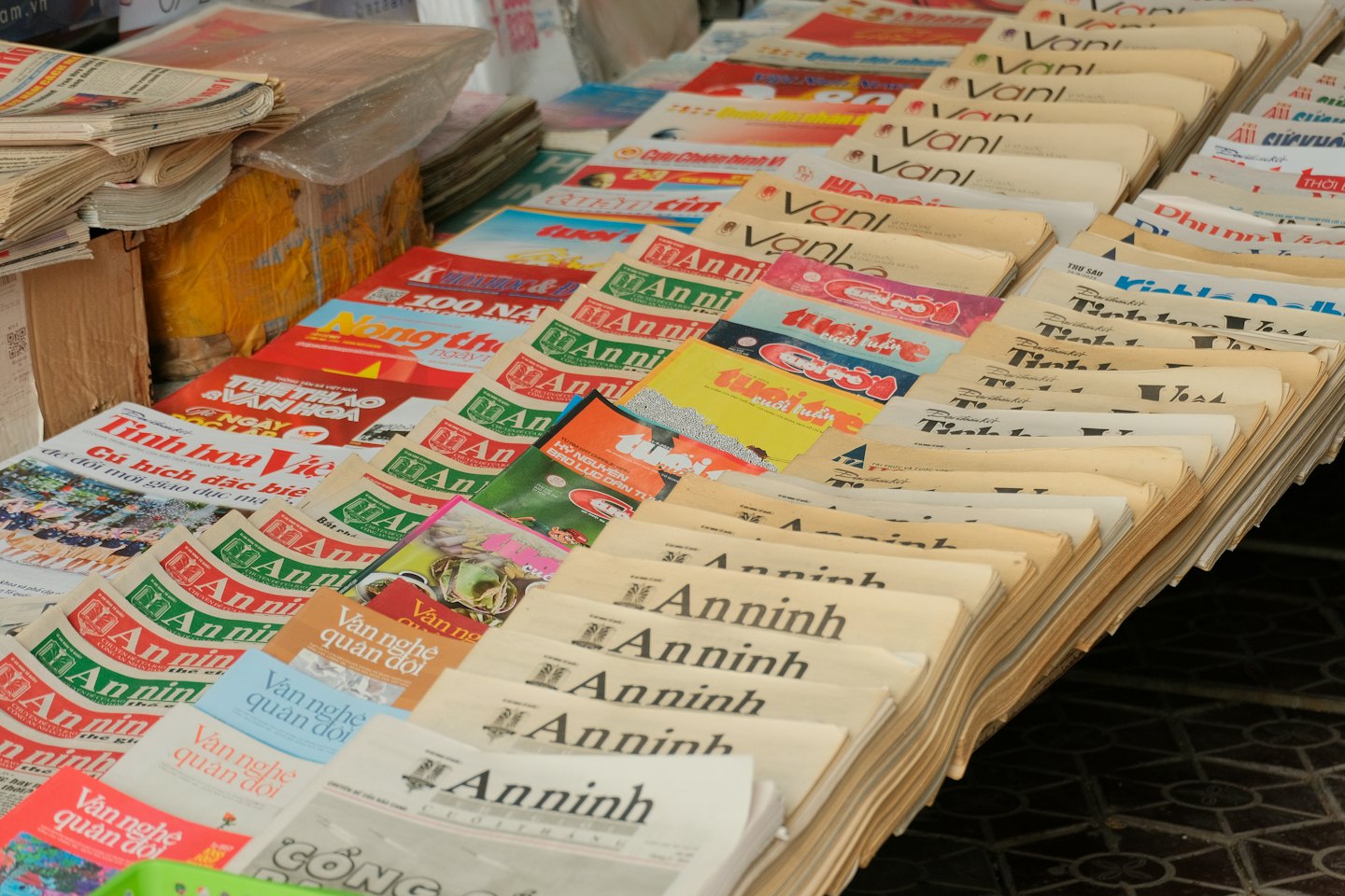Vari giornali e riviste sono a ventaglio su un'edicola.